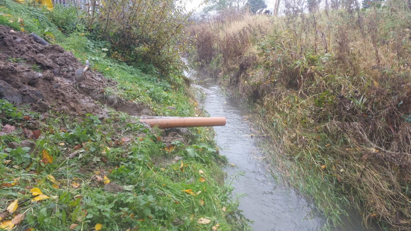 A pipe outfalling into a ditch