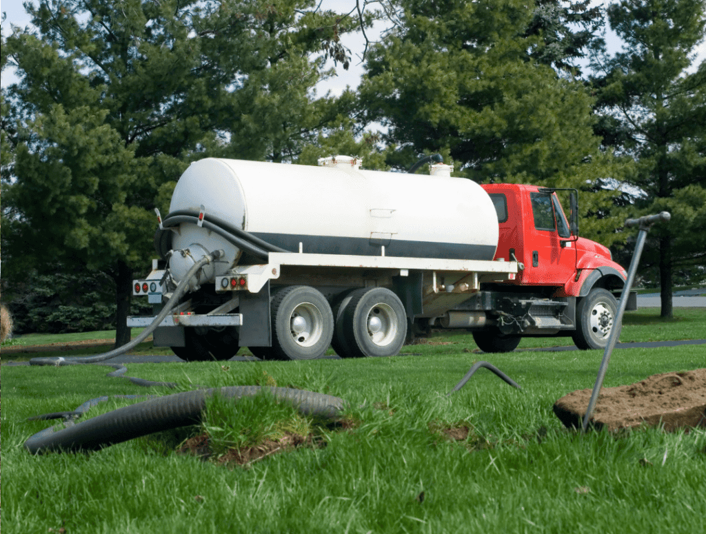 Septic tank desludger emptying a septic tank