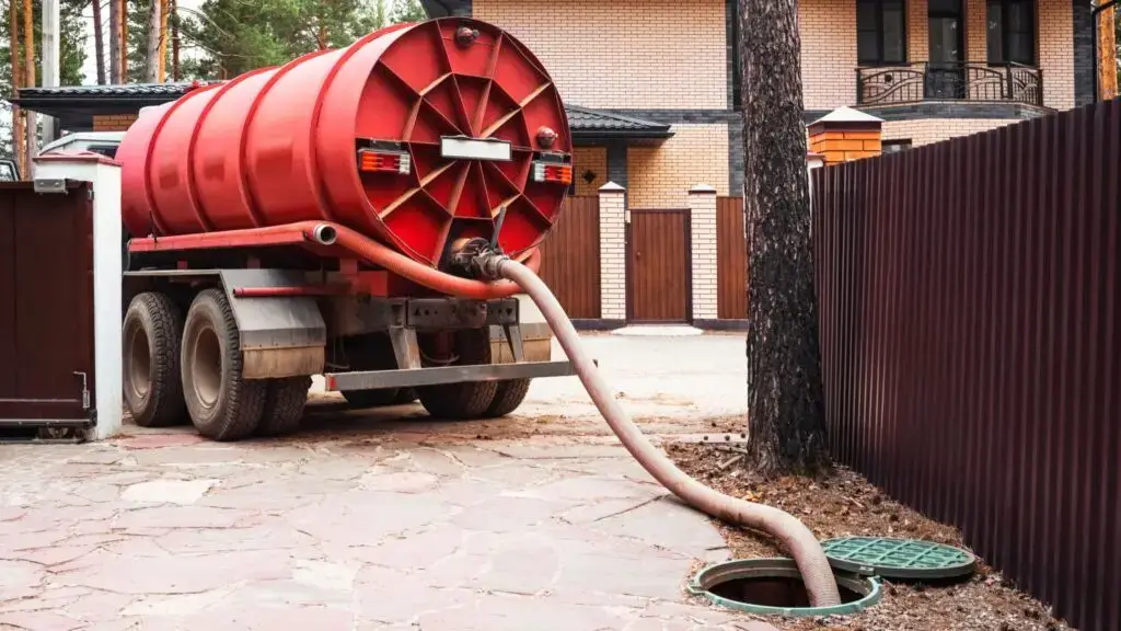 septic tank emptying stock image showing septic tank desludger pumping out a septic tank.