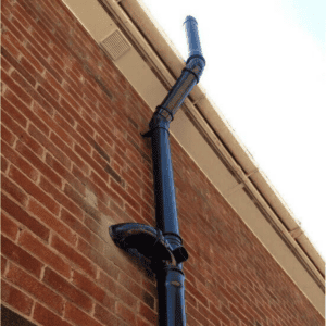 Sewage stack pipe against house above roof level sewage tips