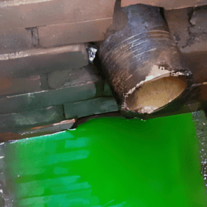 vegetable dye discharging from a septic tank outlet pipe