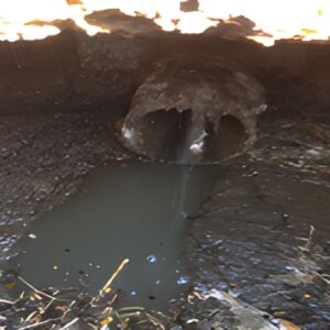 Low quality effluent and dirty water flowing through a brick septic tank repaired in Lincoln