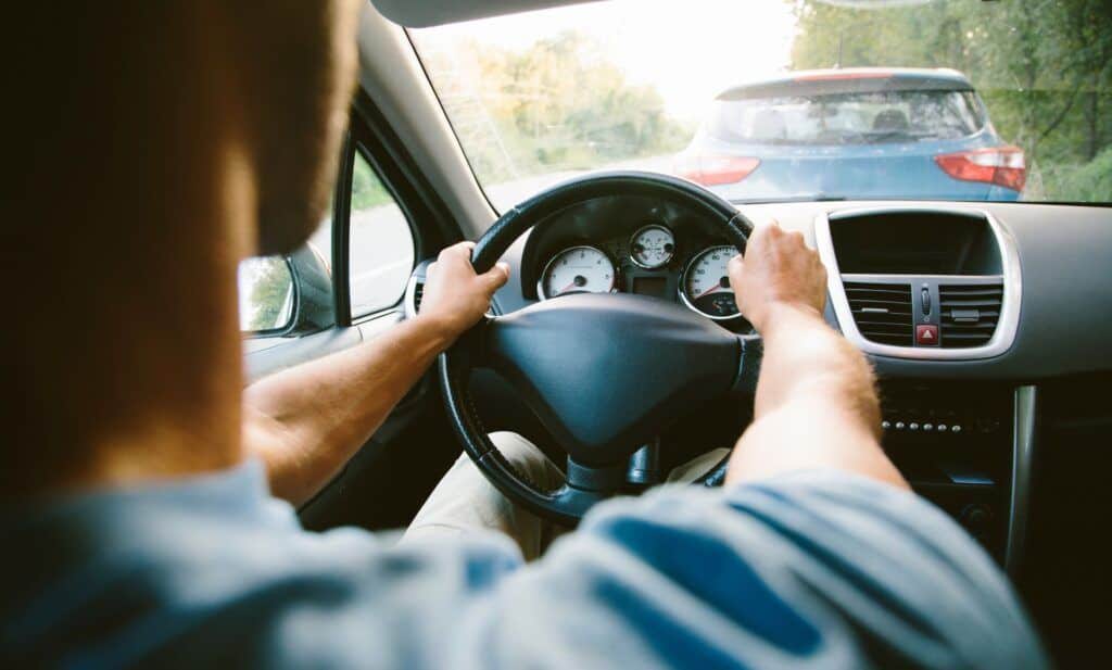 Business man in shirt driving