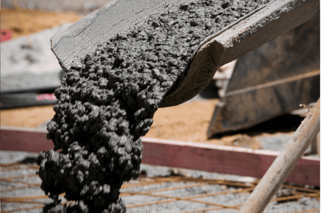 Pouring concrete from a large cement mixer for local building work